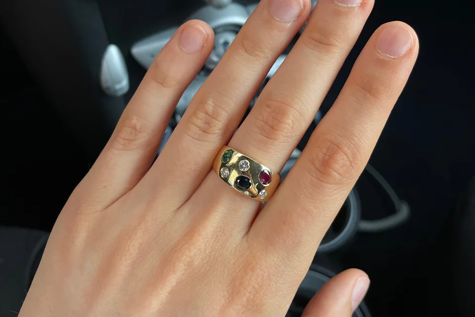 A hand with a vintage gold ring